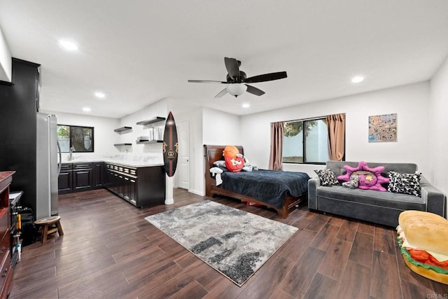 bedroom featuring sink, stainless steel refrigerator, and ceiling fan