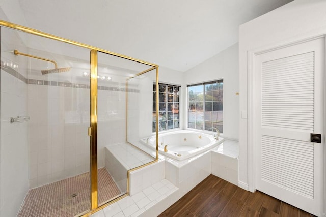 bathroom featuring lofted ceiling, shower with separate bathtub, and hardwood / wood-style floors