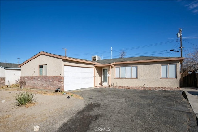 single story home with a garage and central AC