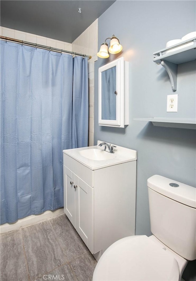 bathroom featuring vanity, toilet, and a shower with shower curtain