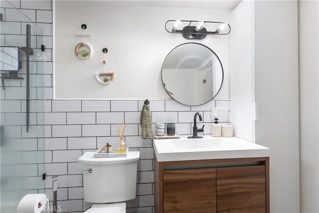 bathroom with toilet, tasteful backsplash, a shower, tile walls, and vanity