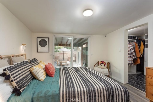 bedroom featuring a closet, a spacious closet, and light hardwood / wood-style floors