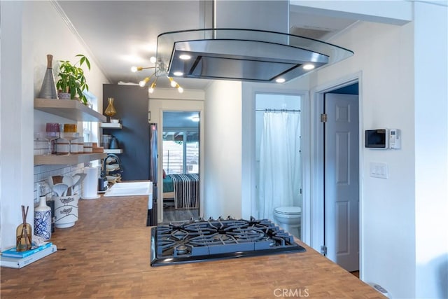 kitchen with sink, gas stovetop, and crown molding