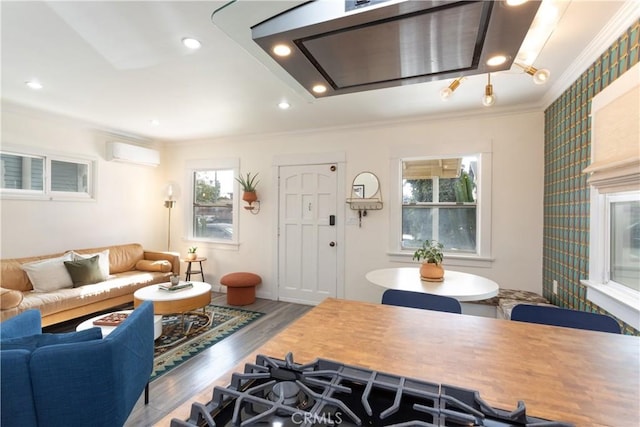 living room featuring an AC wall unit, crown molding, and wood-type flooring