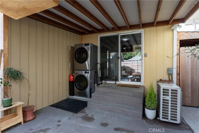 property entrance with stacked washer / dryer