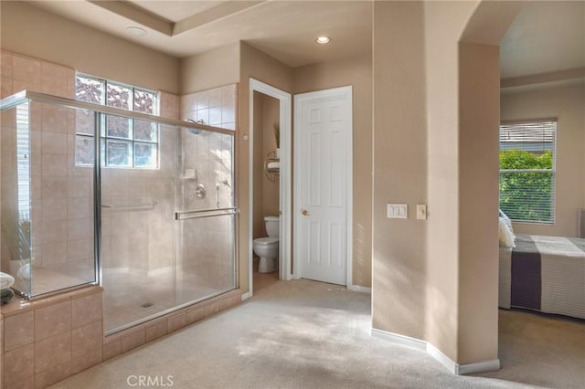 bathroom featuring toilet and an enclosed shower