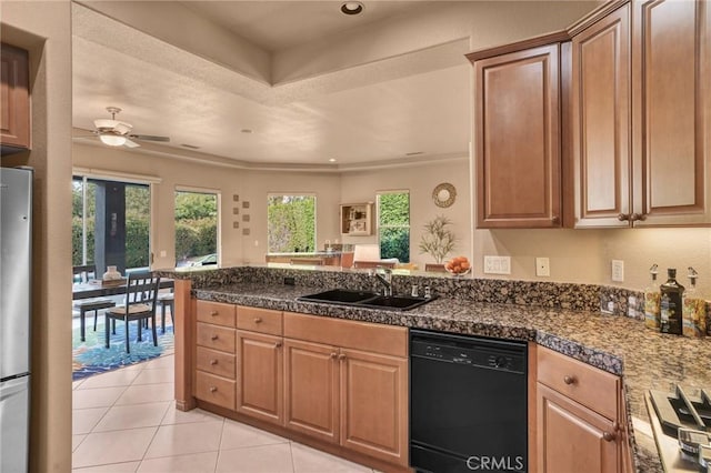 kitchen featuring light tile patterned flooring, refrigerator, black dishwasher, sink, and ceiling fan