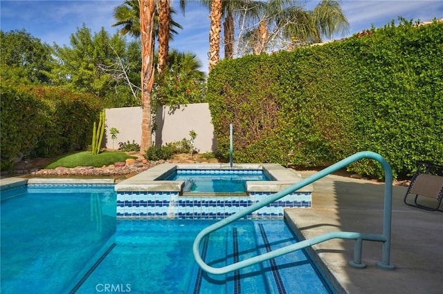 view of swimming pool featuring an in ground hot tub and a patio area