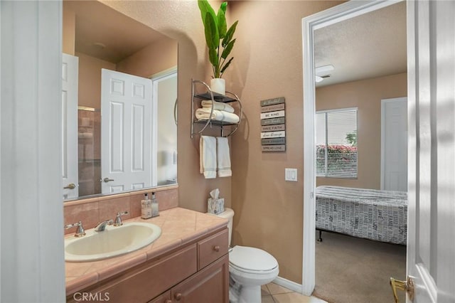 bathroom with tile patterned floors, vanity, and toilet