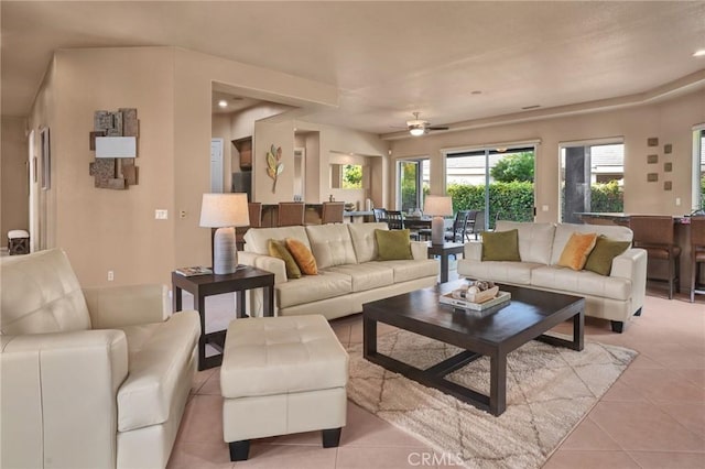 tiled living room with ceiling fan