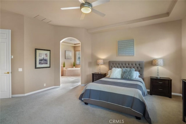 carpeted bedroom with ceiling fan and connected bathroom