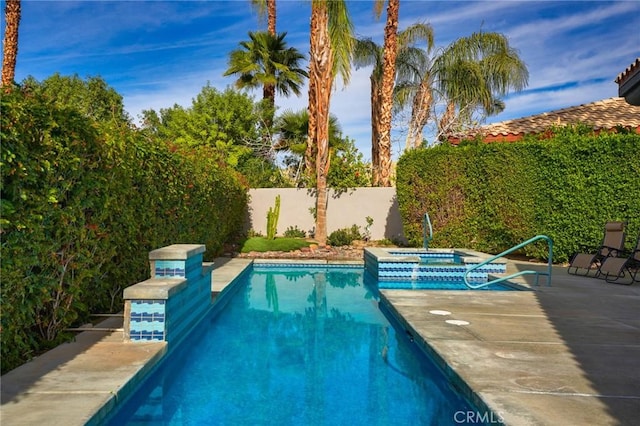 view of swimming pool with a patio area and an in ground hot tub