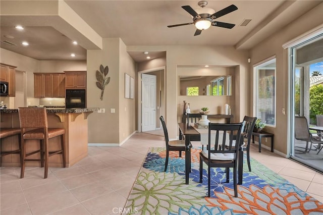 tiled dining room with ceiling fan