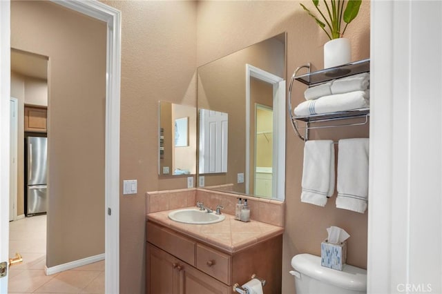 bathroom featuring tile patterned floors, toilet, and vanity