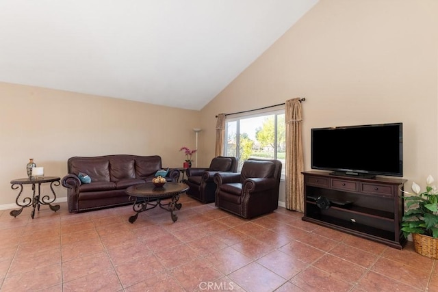 living room featuring tile patterned floors and high vaulted ceiling