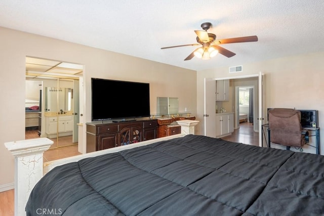 bedroom with light hardwood / wood-style floors, ceiling fan, and a closet