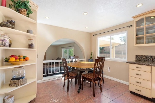 dining space with light tile patterned floors and plenty of natural light