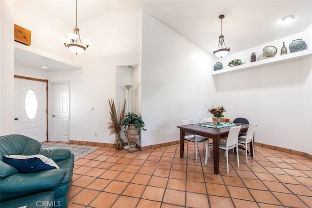 dining space featuring high vaulted ceiling, tile patterned flooring, a notable chandelier, and baseboards