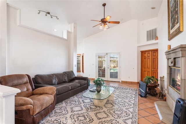 living area featuring high vaulted ceiling, french doors, visible vents, and light tile patterned flooring