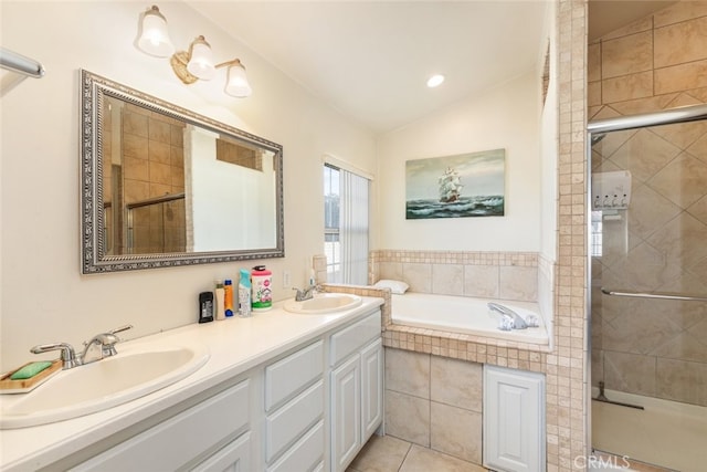 bathroom with a stall shower, lofted ceiling, a garden tub, and a sink