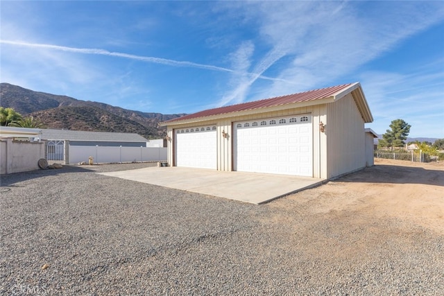 detached garage with fence and a mountain view