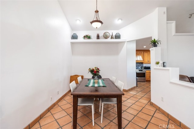 dining room with baseboards and light tile patterned floors