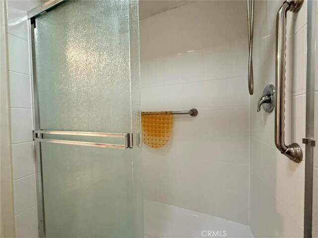 bathroom with a shower with shower door