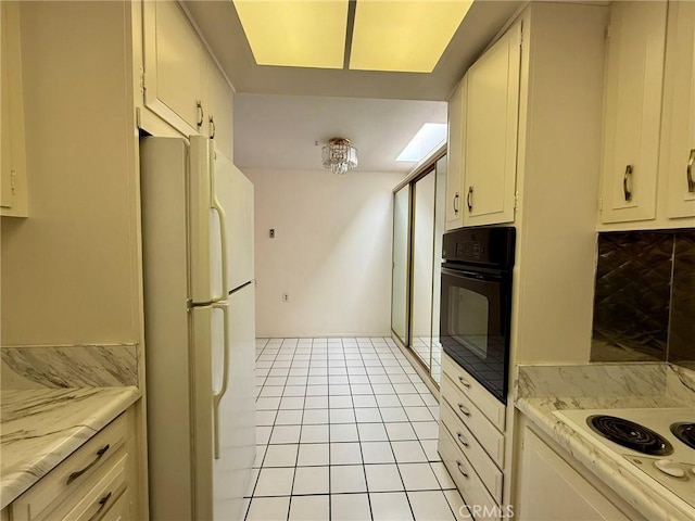 kitchen with light tile patterned floors, white appliances, and backsplash