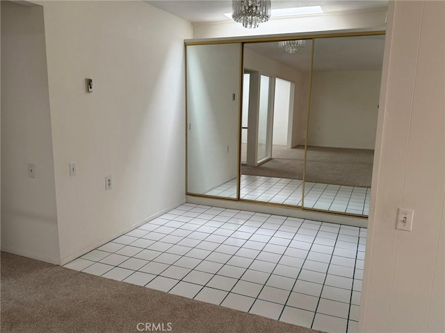 interior space featuring an inviting chandelier and light colored carpet