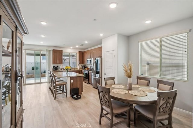 dining space with light hardwood / wood-style floors