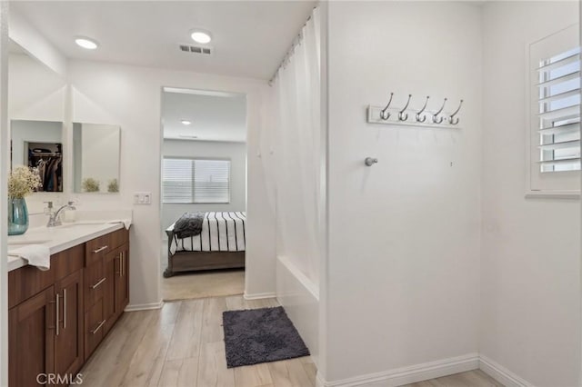 bathroom with vanity and hardwood / wood-style flooring