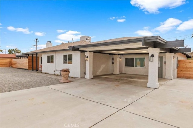 back of property with a carport