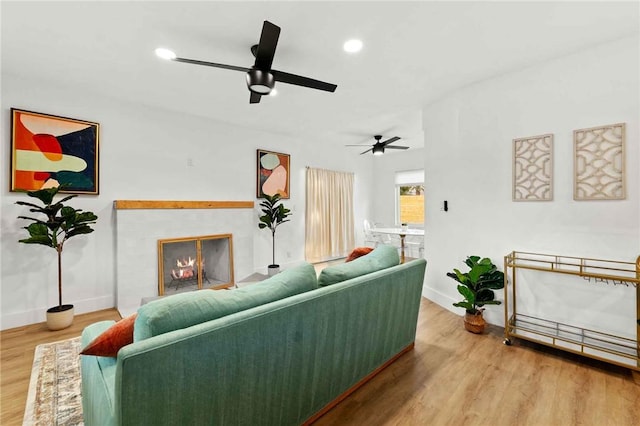 living room with hardwood / wood-style floors and a fireplace