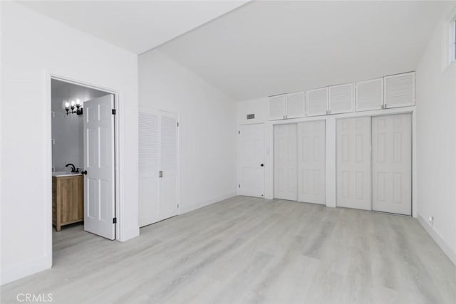 unfurnished bedroom featuring light hardwood / wood-style floors and ensuite bathroom