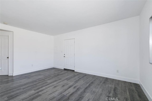 empty room featuring dark hardwood / wood-style flooring