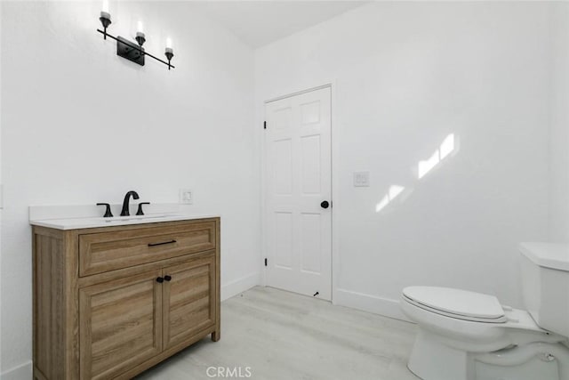 bathroom featuring toilet and vanity