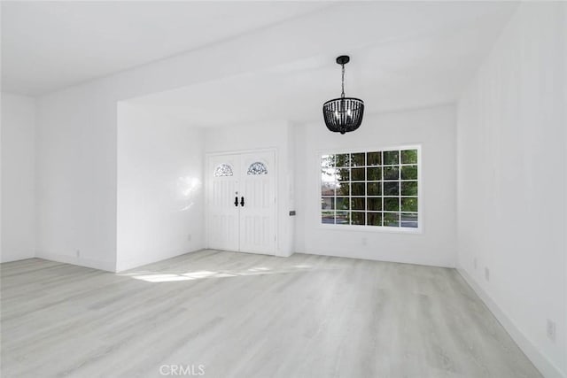 interior space featuring a chandelier and light wood-type flooring