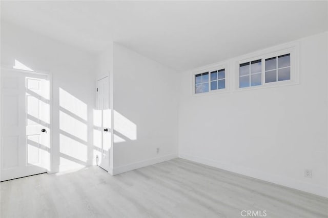 spare room featuring light wood-type flooring