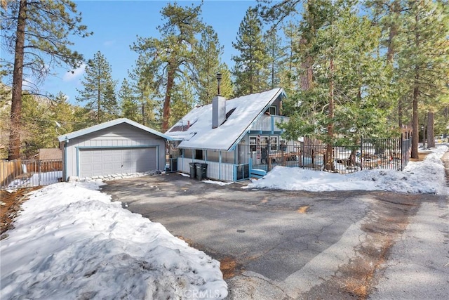 view of front of property featuring a garage and an outdoor structure