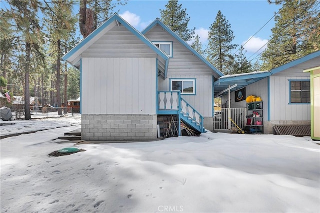 view of snow covered rear of property