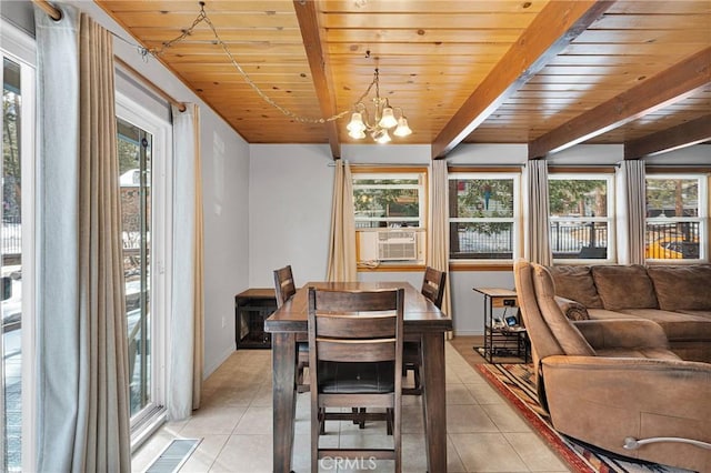 dining area featuring cooling unit, a wealth of natural light, and light tile patterned flooring