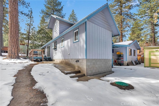 view of snowy exterior featuring a wooden deck