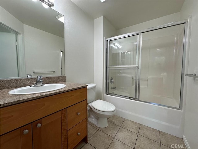 full bathroom with toilet, vanity, tile patterned floors, and combined bath / shower with glass door