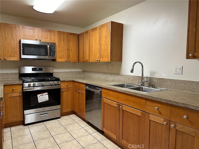 kitchen featuring sink, stainless steel appliances, and light tile patterned flooring