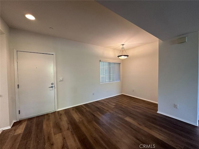 unfurnished room with dark hardwood / wood-style flooring