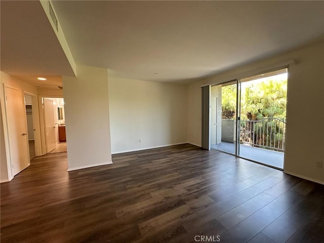 spare room featuring dark hardwood / wood-style flooring