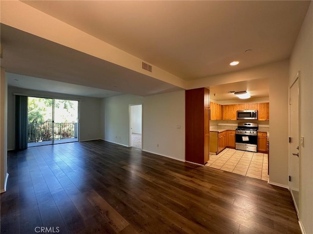 kitchen with stainless steel appliances and light hardwood / wood-style flooring