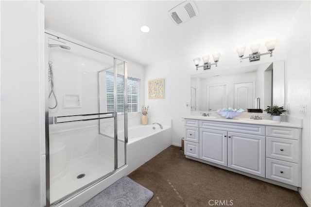 bathroom featuring vanity and shower with separate bathtub