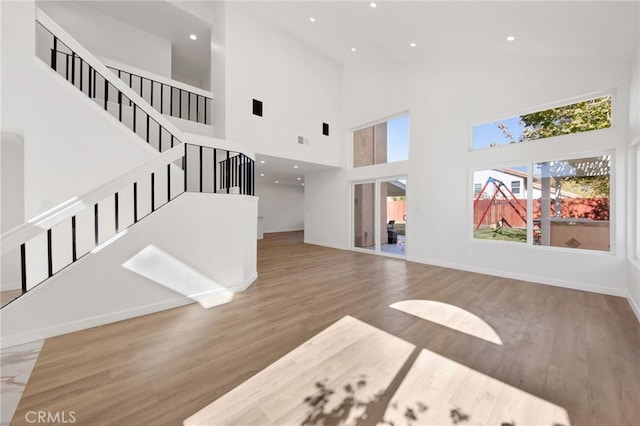 living room featuring hardwood / wood-style floors and a towering ceiling