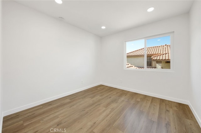 spare room featuring light hardwood / wood-style floors